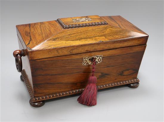 An early 19th century mother of pearl-inlaid rosewood sarcophagus tea caddy